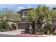 Charming two-story home showcasing a well-manicured yard with mature trees, neutral color palette, and an attached two-car garage at 9950 Coyote Echo Ct, Las Vegas, NV 89166