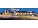 Elegant building with a combination of stone and stucco exterior, showcasing a covered patio and well-lit parking area at 9950 Coyote Echo Ct, Las Vegas, NV 89166