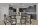 Stylish kitchen with granite countertops, stainless steel appliances, dark wood cabinets, and a backsplash at 9950 Coyote Echo Ct, Las Vegas, NV 89166