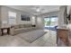 Comfortable living room with a ceiling fan and view to the backyard at 9950 Coyote Echo Ct, Las Vegas, NV 89166