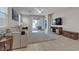 Bright living room with sliding glass doors and tile flooring at 9950 Coyote Echo Ct, Las Vegas, NV 89166