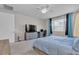 Comfortable main bedroom featuring a workspace and large window at 9950 Coyote Echo Ct, Las Vegas, NV 89166