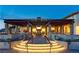 Chic outdoor patio with an inviting fireplace and decorative pergola, ideal for relaxation and gatherings at 9950 Coyote Echo Ct, Las Vegas, NV 89166