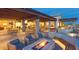 Elegant patio with a fire pit, ample seating, and stylish pergolas, perfect for outdoor entertaining at 9950 Coyote Echo Ct, Las Vegas, NV 89166