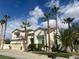 Inviting two-story home with a well-manicured lawn and mature palm trees at 10 Gulf Pines Ave, Las Vegas, NV 89148