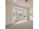 Bright bedroom features plush carpet, recessed lighting, and a bay window overlooking the landscaped backyard at 10421 Linfield Pl, Las Vegas, NV 89134