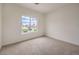 Bedroom with large window overlooking the front yard, allowing natural light to illuminate the room at 10421 Linfield Pl, Las Vegas, NV 89134