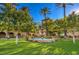 Well maintained tiered fountain in the middle of a garden with palm trees and trimmed shrubs at 10421 Linfield Pl, Las Vegas, NV 89134