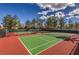 Well-maintained tennis courts, lined by trees, offering a great recreational space at 10421 Linfield Pl, Las Vegas, NV 89134