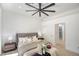 Bright, serene bedroom featuring a king bed with neutral bedding and a walk-in shower within view at 10709 Hunters Woods Pl, Las Vegas, NV 89134