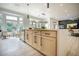 Spacious kitchen island featuring a sink, wooden cabinets, and views to the backyard at 10709 Hunters Woods Pl, Las Vegas, NV 89134