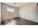 This bedroom features a window with blinds and wood-look laminate flooring at 10719 Tottenham Ave, Las Vegas, NV 89135