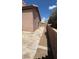 Backyard with concrete patio, low-maintenance gravel area, fence and the side of the house at 1081 Overture Dr, Las Vegas, NV 89123