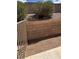 An enclosed backyard area with low-maintenance gravel landscaping and cinder block retaining wall at 1081 Overture Dr, Las Vegas, NV 89123