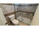 Bathroom featuring a toilet and walk-in shower with tile and a glass enclosure at 1081 Overture Dr, Las Vegas, NV 89123