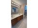 Bathroom featuring a dual sink vanity, tile flooring, and enclosed shower at 1081 Overture Dr, Las Vegas, NV 89123