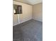 Bedroom with neutral carpet, light-colored walls, and bathroom access at 1081 Overture Dr, Las Vegas, NV 89123