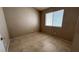Bedroom with neutral paint and tile flooring with a view to the exterior at 1081 Overture Dr, Las Vegas, NV 89123