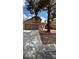 Exterior view of a two story home with a wide driveway, a lawn and mature shade tree at 1081 Overture Dr, Las Vegas, NV 89123