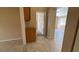 Hallway featuring tile flooring, cabinetry, and doors leading to different rooms at 1081 Overture Dr, Las Vegas, NV 89123