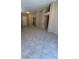 An open living area features ample space, tile flooring, and neutral paint throughout at 1081 Overture Dr, Las Vegas, NV 89123