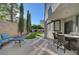 Inviting backyard featuring artificial turf and an outdoor seating area with a covered patio at 11417 Rock Cove Way, Las Vegas, NV 89141