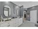Modern bathroom featuring double sinks, quartz countertop, stylish mirrors and clean, grey walls at 11417 Rock Cove Way, Las Vegas, NV 89141