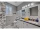 Charming bathroom featuring double sinks, gray countertops, playful shower curtain, and white cabinets at 11417 Rock Cove Way, Las Vegas, NV 89141
