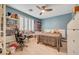 Bright bedroom with wood floors, ceiling fan and a large window to let in natural light at 11417 Rock Cove Way, Las Vegas, NV 89141