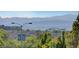 A scenic view of the community with lush greenery, rolling hills, and distant mountains at 11417 Rock Cove Way, Las Vegas, NV 89141