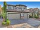 Charming two-story home featuring a three car garage, neutral stucco exterior and well maintained landscaping at 11417 Rock Cove Way, Las Vegas, NV 89141