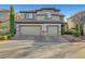 Two-story home featuring a three car garage, neutral stucco and stone accents plus well maintained landscaping at 11417 Rock Cove Way, Las Vegas, NV 89141