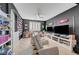 Entertainment space with multiple screens, comfortable seating, and shelving to display collections and memorabilia at 11417 Rock Cove Way, Las Vegas, NV 89141