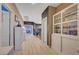 Bright, spacious hallway featuring wood floors, display shelving and neutral decor leading to bedrooms at 11417 Rock Cove Way, Las Vegas, NV 89141