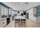 Bright kitchen with white cabinets, an island, stainless steel appliances, and blue accent wall at 11417 Rock Cove Way, Las Vegas, NV 89141