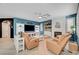 Open floor plan with cozy living space featuring white brick fireplace and comfortable furniture at 11417 Rock Cove Way, Las Vegas, NV 89141