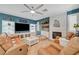 Comfortable living room with fireplace, sectional couch, and natural lighting at 11417 Rock Cove Way, Las Vegas, NV 89141