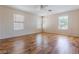 Spacious bedroom with natural light, wood floors and multiple windows at 11577 Vesuvio Ct, Las Vegas, NV 89183