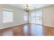 Dining room with wood floors, a modern chandelier and sliding glass doors at 11577 Vesuvio Ct, Las Vegas, NV 89183