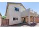 Exterior of home with stucco facade, upper level balcony, and a covered patio at 11577 Vesuvio Ct, Las Vegas, NV 89183