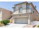 Two-story stucco home featuring a two car garage and tile roof at 11577 Vesuvio Ct, Las Vegas, NV 89183