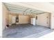 Open garage with installed water heater, storage closet and overhead lighting at 11577 Vesuvio Ct, Las Vegas, NV 89183