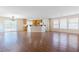 Open floor plan living room with wood floors that flows into the kitchen at 11577 Vesuvio Ct, Las Vegas, NV 89183