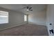 Bright bedroom features neutral carpeting, ceiling fan and natural light from windows at 1180 Lava Ave, Jean, NV 89019