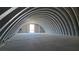 Spacious metal building with arched ceilings, concrete floor and an open entrance at 1180 Lava Ave, Jean, NV 89019