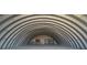 Large, arched metal building with an open interior featuring shelving units at 1180 Lava Ave, Jean, NV 89019