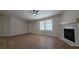 Bright open living room features a fireplace, ceiling fan and laminate wood floors at 1180 Lava Ave, Jean, NV 89019