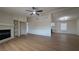 Open-concept living room boasts a fireplace, ceiling fan, and wood-look flooring at 1180 Lava Ave, Jean, NV 89019