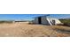 Overview shot of the property, featuring the house and garage with desert landscape at 1180 Lava Ave, Jean, NV 89019