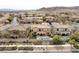 Aerial view of a home with a pristine backyard pool and spa, enhanced by solar panels and lush landscaping in a desert setting at 12116 Vista Linda Ave, Las Vegas, NV 89138